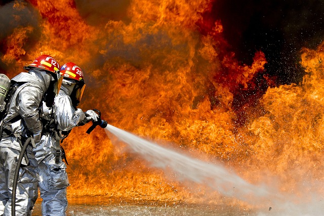 Image contains firefighters extinguishing fire using water